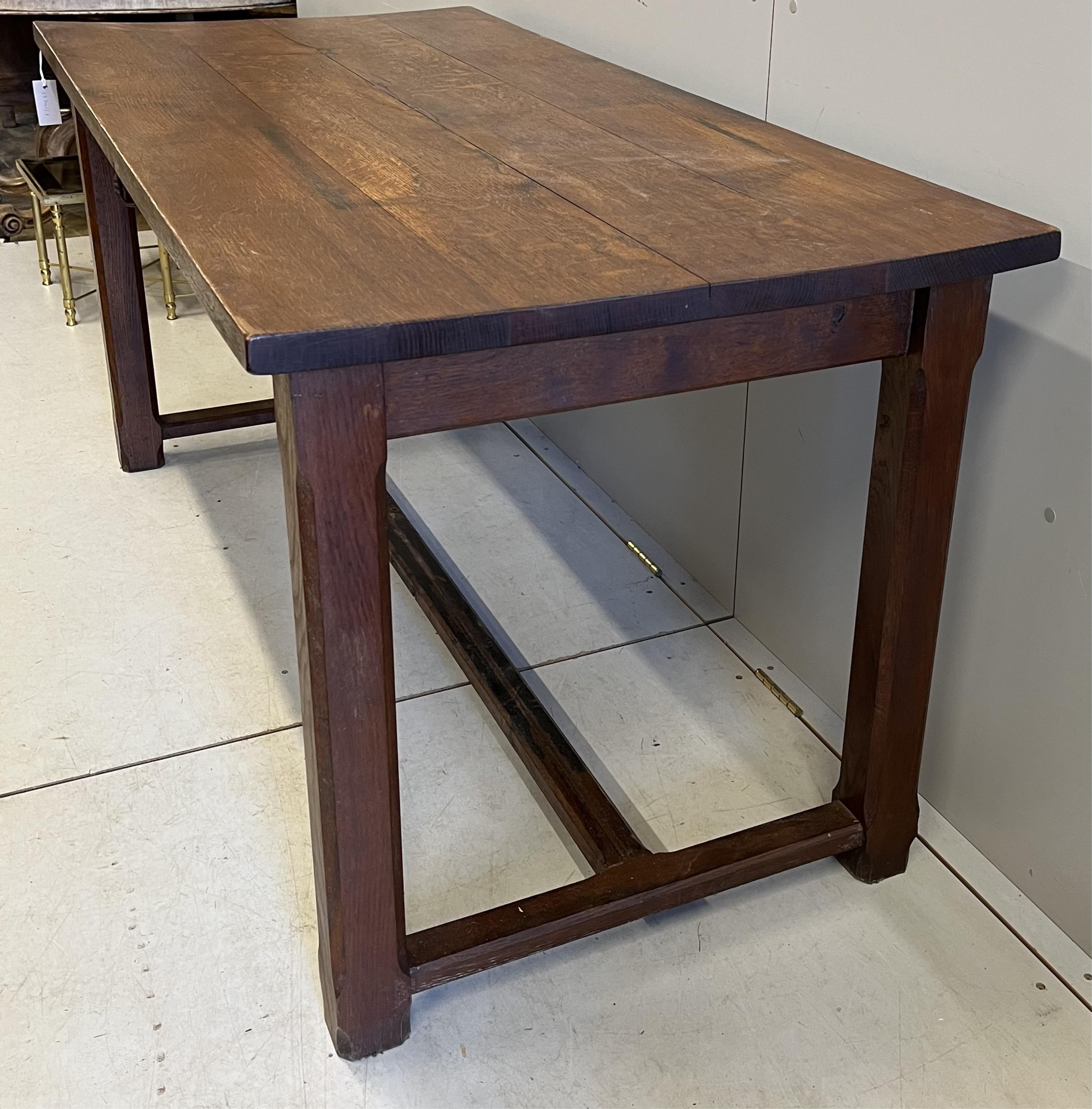 An early 20th century French rectangular oak kitchen table, on chamfered square legs, width 159cm, depth 74cm, height 76cm